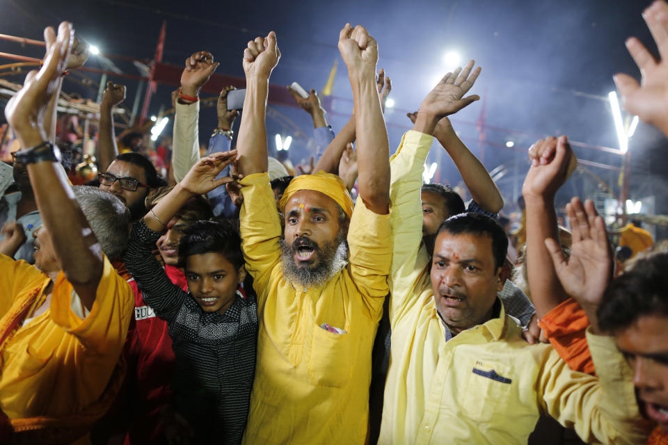 Hindu devotees celebrate the verdict in a decades-old land title dispute between Muslims and Hindus, in Ayodhya, India , Saturday, Nov. 9, 2019. India's Supreme Court on Saturday ruled in favor of a Hindu temple on a disputed religious ground and ordered that alternative land be given to Muslims to build a mosque. The dispute over land ownership has been one of the country's most contentious issues. (AP Photo/Rajesh Kumar Singh)