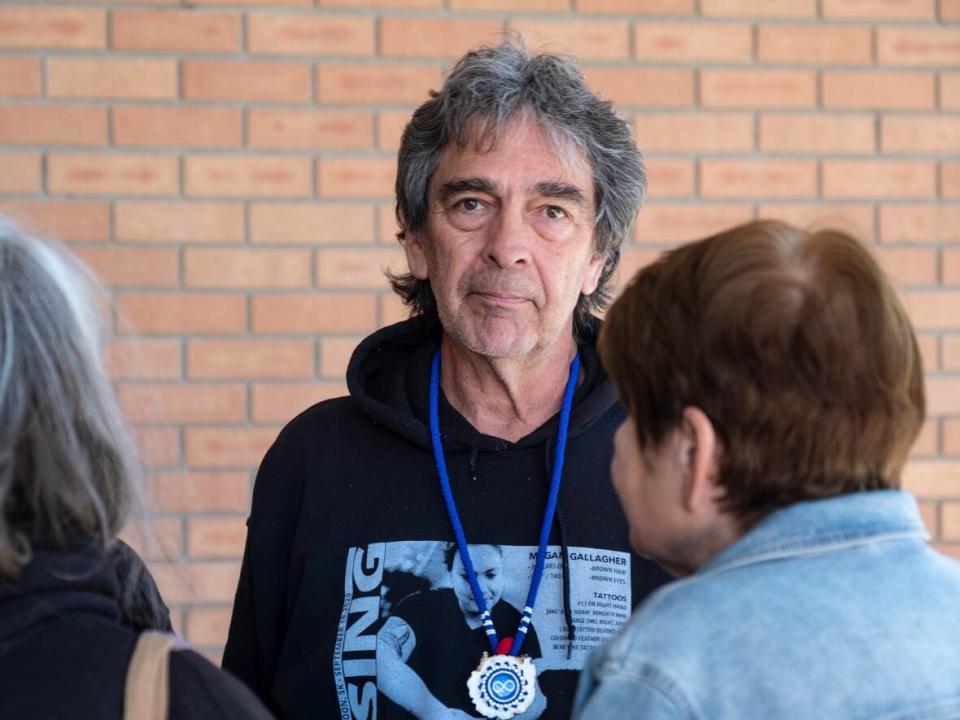 Brian Gallagher stands outside the provincial courthouse in Saskatoon on Oct. 3, 2022 following a brief court appearance for Jessica Sutherland (Badger), who is charged with committing an indignity to human remains in connection with the suspected killing of Megan Gallagher.  (Kendall Latimer/CBC - image credit)