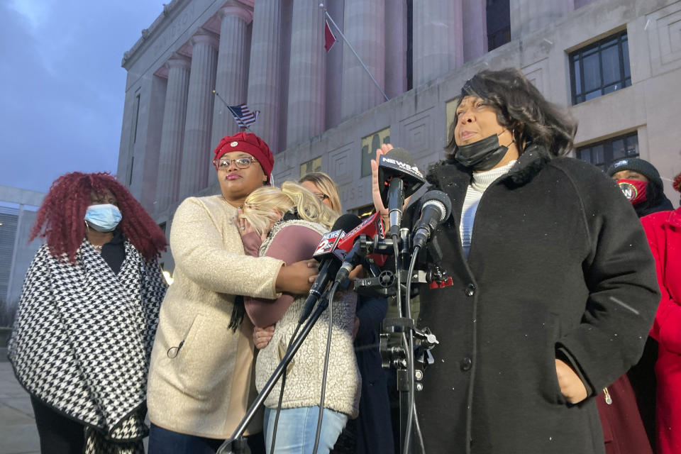 CORRECTS SPELLING OF FIRST NAME TO CHELESY, NOT CHELSEY - Defense attorney Joy Kimbrough, addresses the media outside the Nashville Metro Courthouse, Friday, Jan. 28, 2022, in Nashville, Tenn, as Chelesy Eastep, third from left, is comforted. Authorities on the day before had pleaded with 37-year-old Landon Eastep to surrender while keeping him at gunpoint, but killed him when he pulled another shiny object from his pocket and pointed it at police as if ready to shoot. That object turned out not to be a gun. Kimbrough called the shooting a “firing squad execution.”(AP Photo/Kimberlee Kruesi)