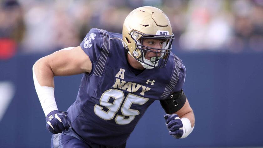 Navy Midshipmen defensive end Jacob Busic runs forward during a NCAA game against Tulsa