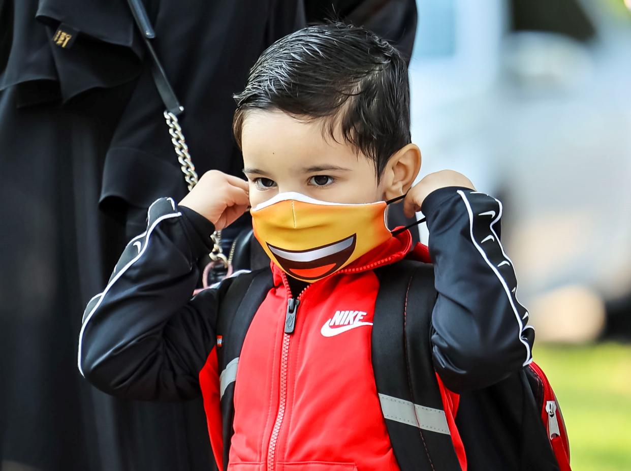 A student puts on a mask at Philip Rogers Elementary School in Chicago, on Aug. 30, 2021.(Photo by Joel Lerner/Xinhua via Getty Images)