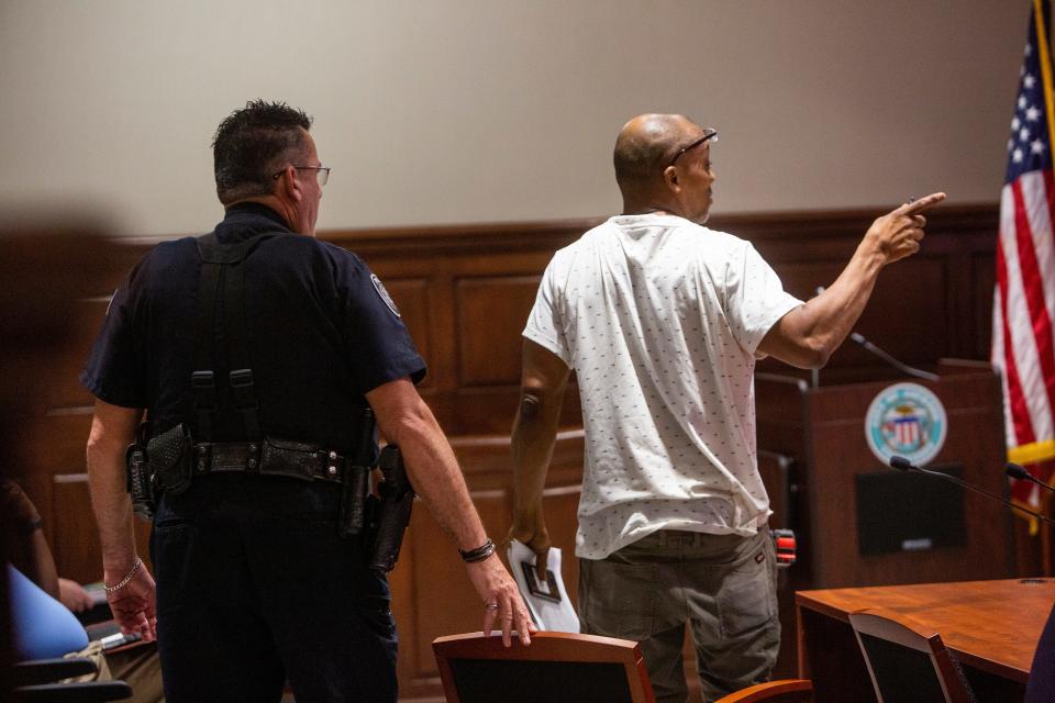 "You are not king," says Billy Moore (right), as he points at Mayor Scott Conger while being removed during public comment, after arguing about a proposed surplus property policy during a city council meeting on August 2, 2022, in Jackson, TN.