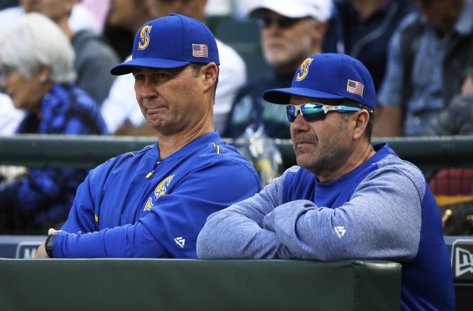 FILE - In this Sept. 10, 2017, file photo, Seattle Mariners manager Scott Servais, left, and hitting coach Edgar Martinez stand at the rail of the dugout during the team's baseball game against the Los Angeles Angels in Seattle. Servais had never crossed paths with Martinez until being hired as Seattle’s manager in 2016. Martinez was the hitting coach under the previous regime and remained on staff. (AP Photo/Ted S. Warren, File)