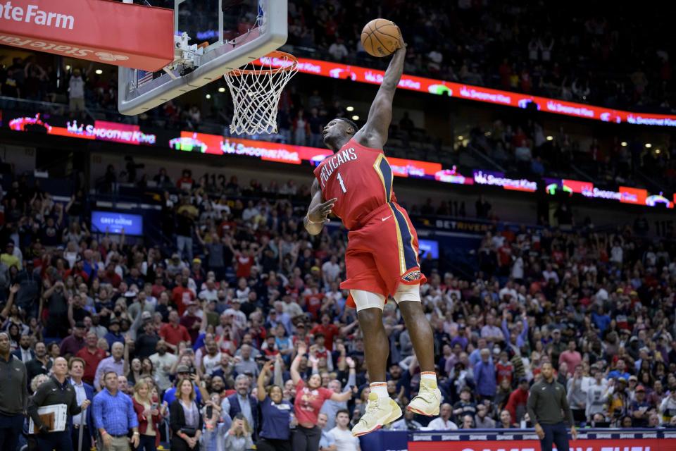 New Orleans Pelicans forward Zion Williamson (1) completes a windmill dunk against the Phoenix Suns in the second half of an NBA basketball game in New Orleans, Friday, Dec. 9, 2022. (AP Photo/Matthew Hinton)