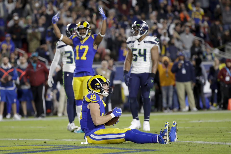 Los Angeles Rams wide receiver Cooper Kupp, bottom, celebrates after scoring during the first half of an NFL football game against the Seattle Seahawks Sunday, Dec. 8, 2019, in Los Angeles. (AP Photo/Marcio Jose Sanchez)
