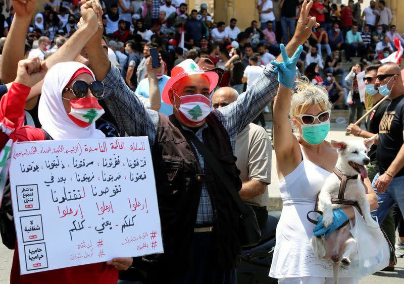 Demonstrators gesture during a protest against the government performance and worsening economic conditions, in Beirut