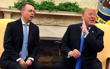 U.S. President Donald Trump gestures as he welcomes Pastor Andrew Brunson, after his release from two years of Turkish detention, in the Oval Office of the White House, Washington, U.S., October 13, 2018. REUTERS/Mike Theiler