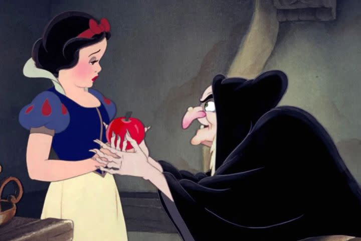 Snow White holding an apple from the Evil Queen in Snow White and the Seven Dwarfs