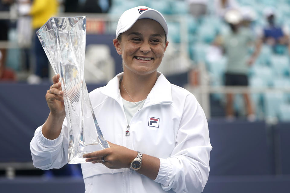 Ashleigh Barty of Australia poses with the trophy after winning her match against Bianca Andreescu of Canada during the finals at the Miami Open tennis tournament, Saturday, April 3, 2021, in Miami Gardens, Fla. Barty won 6-3, 4-0, as Andreescu retired due to injury. (AP Photo/Lynne Sladky)