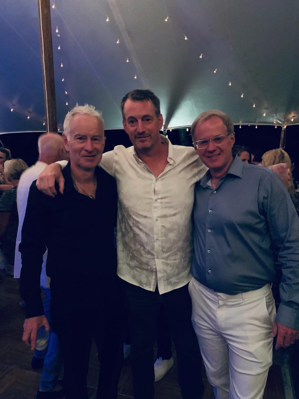 Jay Harris flanked by the McEnroe brothers, John (left) and Patrick.  Harris, a 1989 Lexington High graduate, is director of the John McEnroe Tennis Academy.