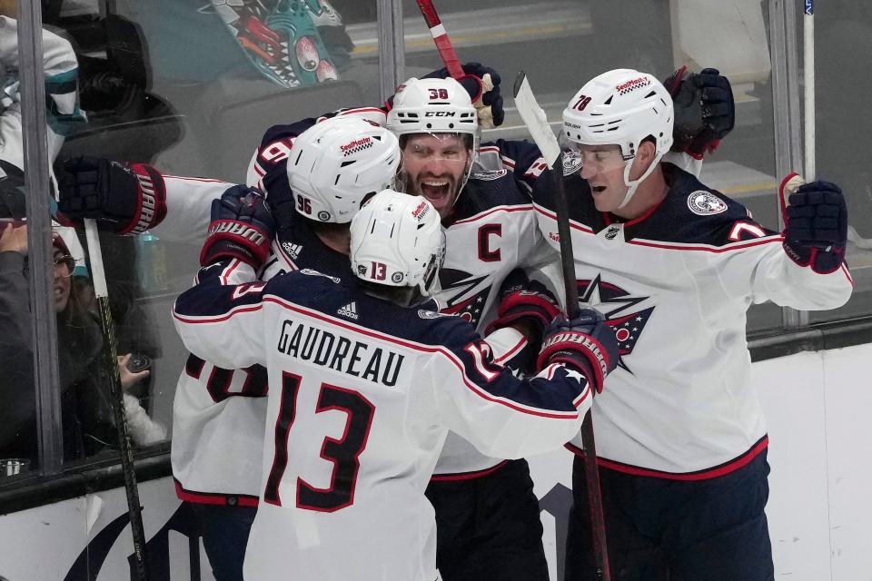 Columbus Blue Jackets center Boone Jenner (38) celebrates with teammates after scoring against the San Jose Sharks during the third period of an NHL hockey game in San Jose, Calif., Saturday, Feb. 17, 2024. (AP Photo/Jeff Chiu)