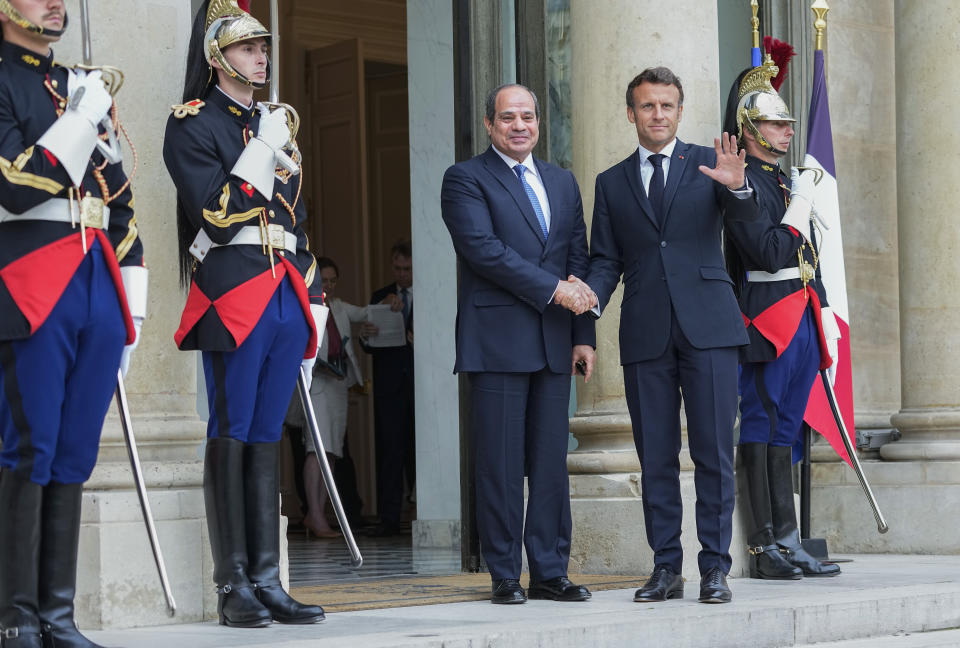 Egyptian President Abdel Fattah el-Sissi, left, is welcomed by French President Emmanuel Macron at the Elysee Palace, Friday, July 22, 2022. (AP Photo/Michel Euler)