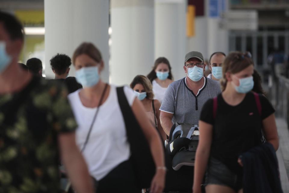 Passengers wearing face masks arrive at Son Sant Joan airport on the Spanish Balearic Island of Mallorca on Monday: AP