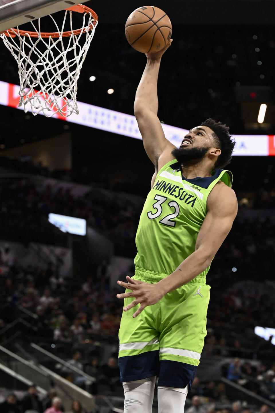 Minnesota Timberwolves' Karl-Anthony Towns dunks during the first half of an NBA basketball game against the San Antonio Spurs on Monday, March 14, 2022, in San Antonio. (AP Photo/Darren Abate)