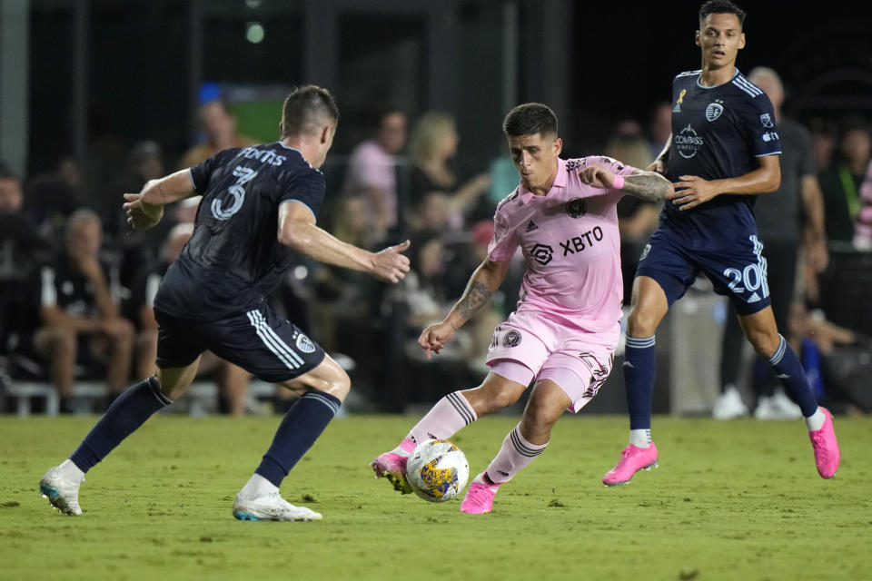 Inter Miami defender Franco Negri, center, battles for the ball with Sporting Kansas City defender Andreu Fontas (3) and forward Daniel Salloi, right, Saturday, Sept. 9, 2023, during the first half of an MLS soccer match in Fort Lauderdale, Fla. (AP Photo/Wilfredo Lee)