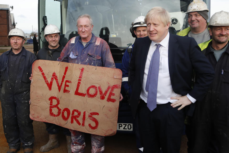 FILE - Britain's Prime Minister Boris Johnson poses with workers during a visit to Wilton Engineering Services, part of a General Election campaign trail stop in Middlesbrough, England, Wednesday, Nov. 20, 2019. The moving vans have already started arriving in Downing Street, as Britain's Conservative Party prepares to evict Johnson. Debate about what mark he will leave on his party, his country and the world will linger long after he departs in September. (AP Photo/Frank Augstein, Pool, File)