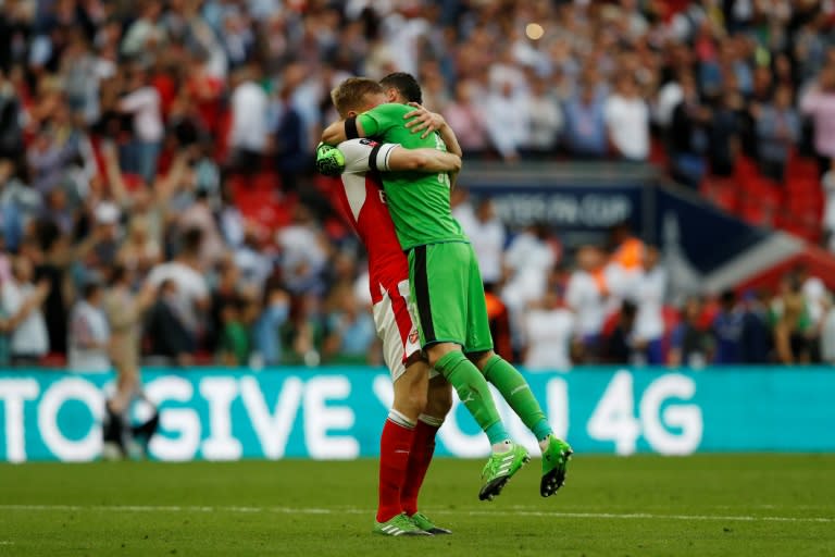 Arsenal's goalkeeper David Ospina and defender Per Mertesacker celebrate their win on the final whistle of their English FA Cup final against Chelsea at Wembley stadium in London on May 27, 2017