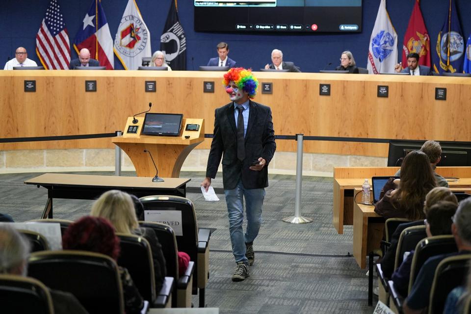 Alex Strenger returns to his seat after speaking during Wednesday's City Council meeting. Strenger, who was dressed as a clown, said he wanted to dress for the job of Austin city manager.