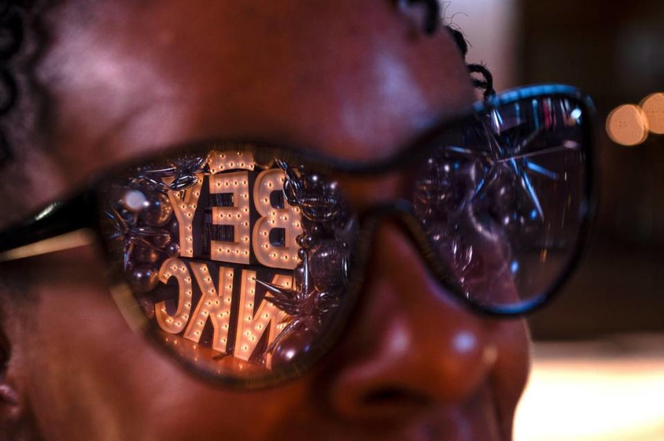 Beverly Reed stands for a portrait as a Beyoncé-themed sign reflects off her sunglasses. The Beyoncé signed lit up the front entrance of Union Station and gave people a chance for a photo opportunity before Queen B’s concert on Sunday.