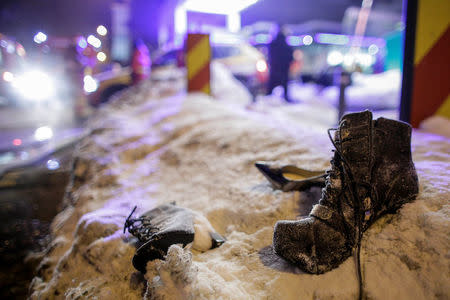 Lady shoes lay abandoned on the snow following the evacuation of a club after a fire broke out in Bucharest, Romania, January 21, 2017. Inquam Photos/Octav Ganea/via REUTERS