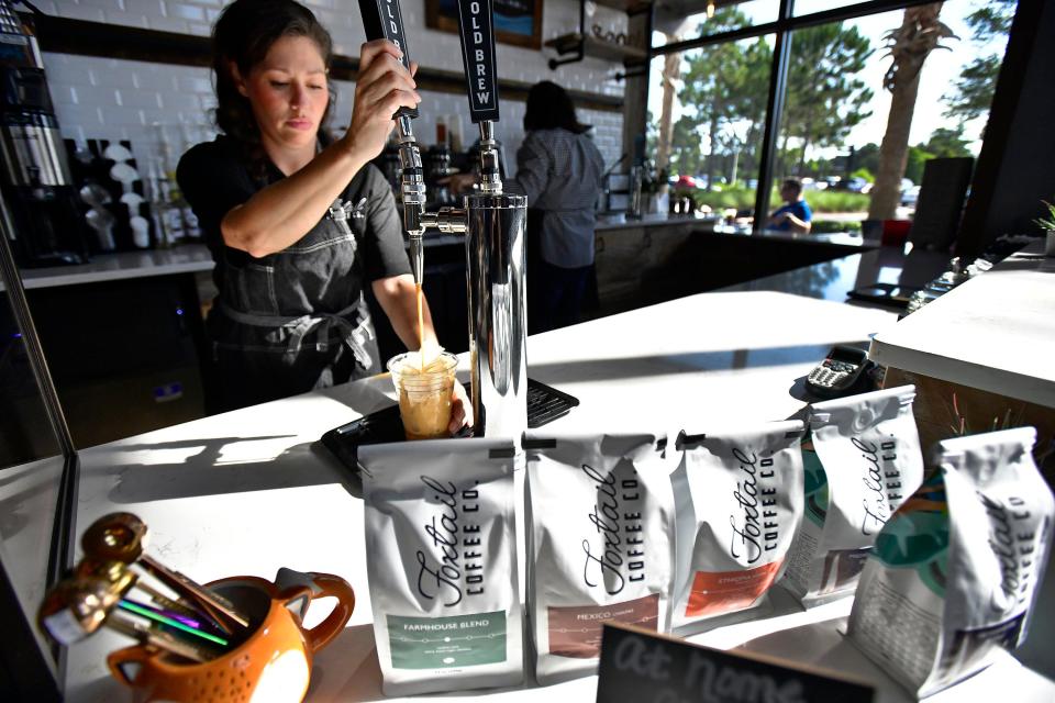 Kim Edwards, head of operations at Foxtail Coffee Co. in Ponte Vedra Beach, pours a customer's cold brew coffee from the tap.