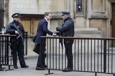 British Member of Parliament Tobias Ellwood shakes hands with an armed police officer as he arrives at the Houses of Parliament, following a recent attack in Westminster, London, Britain March 24, 2017. REUTERS/Darren Staples