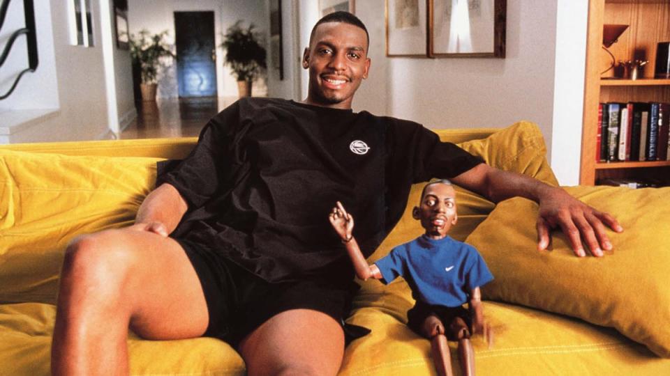 Penny Hardaway sits next to his alter-ego Lil’ Penny as part of a 90s Nike sneaker campaign.