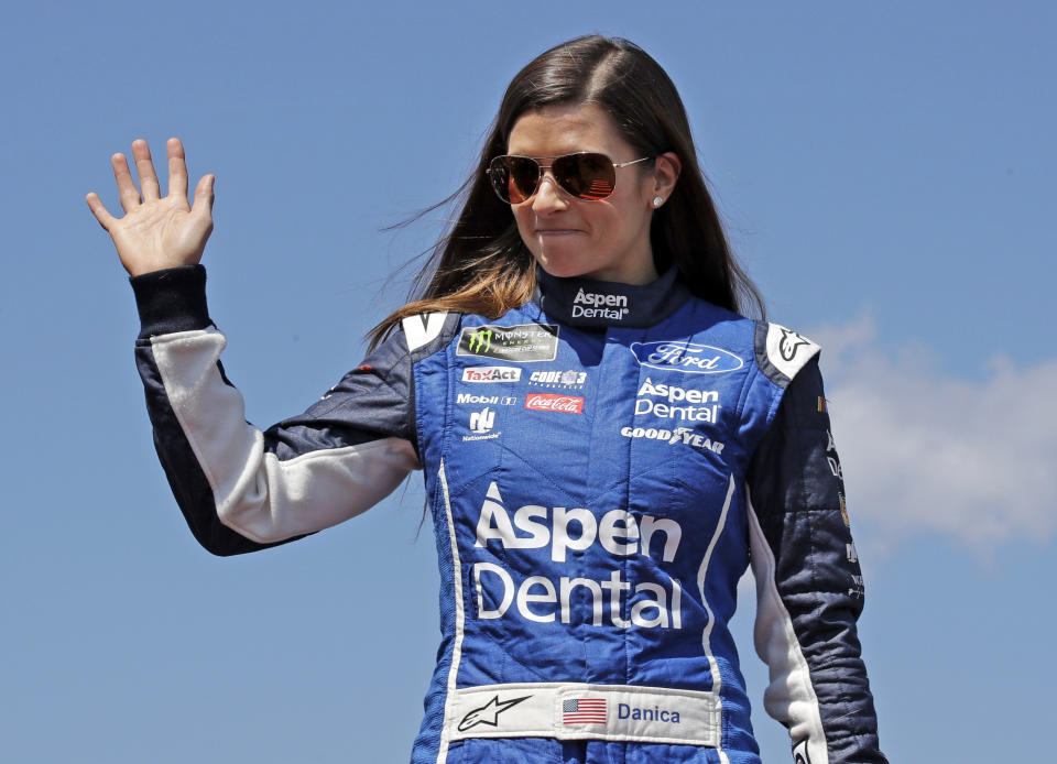 FILE – In this July 16, 2017, file photo, driver Danica Patrick waves prior to the NASCAR Cup Series auto race at the New Hampshire Motor Speedway in Loudon, N.H. Patrick announced plans Friday, Nov. 17, 2017, to run just 2 races in 2018, the Daytona 500 and the Indianapolis 500, and end her full-time driving career. (AP Photo/Charles Krupa, File)