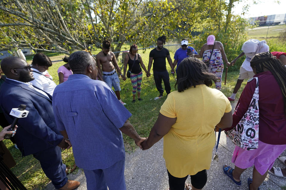 Residents gather for a prayer near the scene of a mass shooting at a Dollar General store, Saturday, Aug. 26, 2023, in Jacksonville, Fla. / Credit: John Raoux / AP