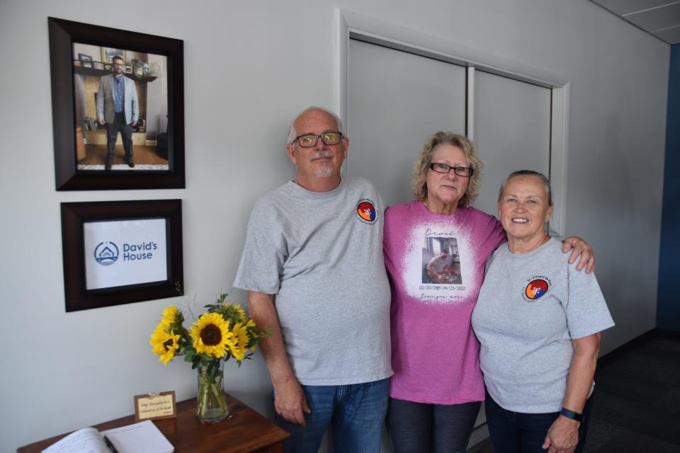 Tony Talbert, left, and his wife Donna Talbert, right, pose with Vicky Greer, the mother of David Marshal for whom the new David’s House St. Vincent de Paul ministry in Richmond was named. Marshall’s photo is seen hanging on the wall.