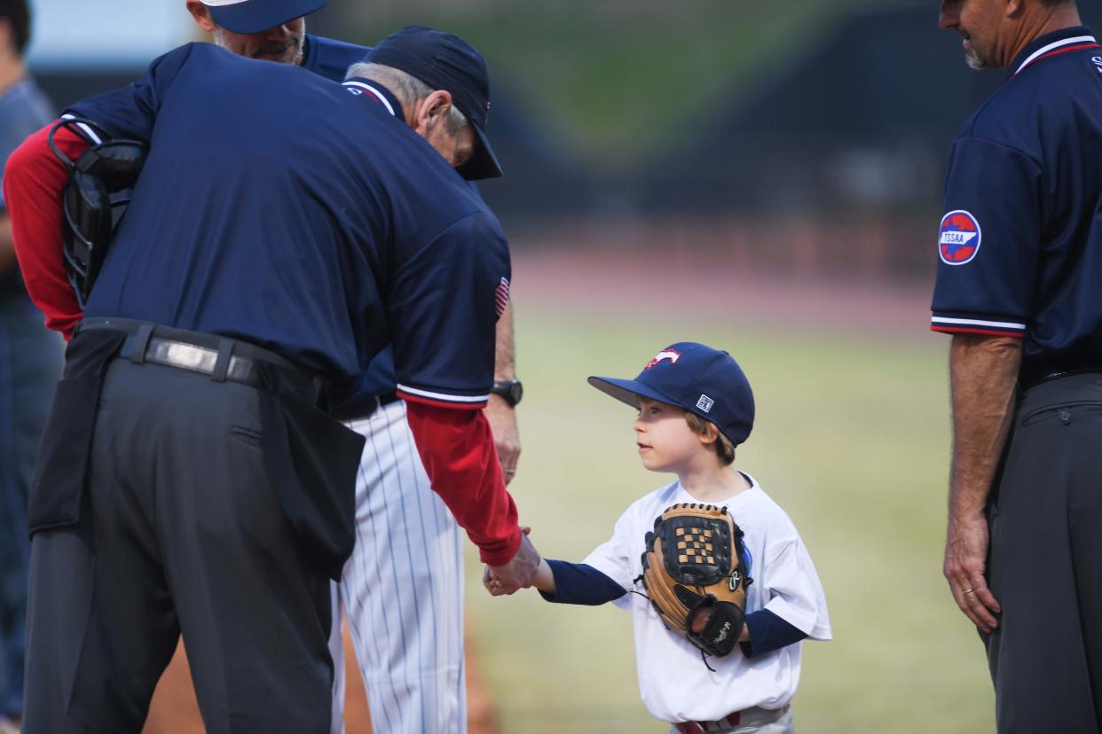 Will Clark, 7 years old with Down syndrome, shakes hands with the officiating crew before the WES's Game match in The Ball Park at Jackson, in Jackson, Tenn., on Thursday, March 21, 2024.