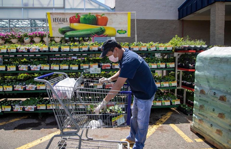 A customer shops outside the garden center at Lowe’s Home Improvement on Capital Boulevard in Raleigh Wednesday, April 8, 2020.