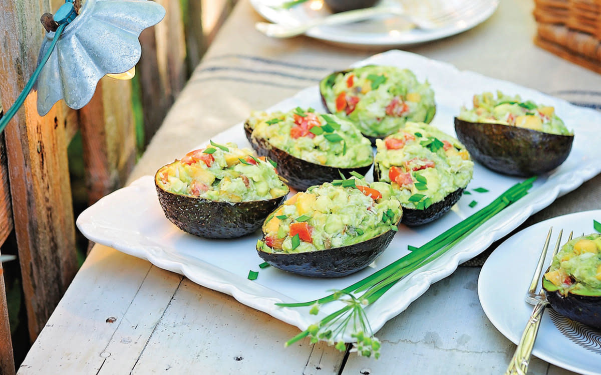 <p>Stephanie Mullins</p><p>Buttery avocado filled with crab, tomatoes and peaches is a light appetizer your guests will love.</p><p><strong>Get the recipe: <a href="https://parade.com/841384/communitytable/crab-salad-avocado-boats/" rel="nofollow noopener" target="_blank" data-ylk="slk:Crab Salad Avocado Boats;elm:context_link;itc:0;sec:content-canvas" class="link rapid-noclick-resp">Crab Salad Avocado Boats</a></strong></p>