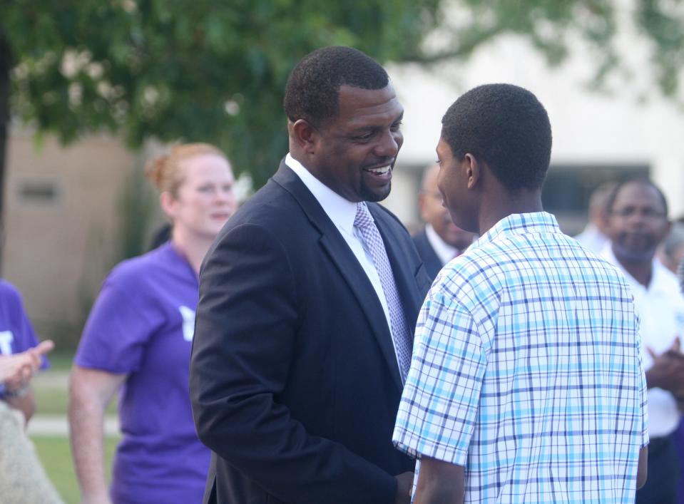 Shaun Nelms, East High's superintendent, greets a student during the first day of school.