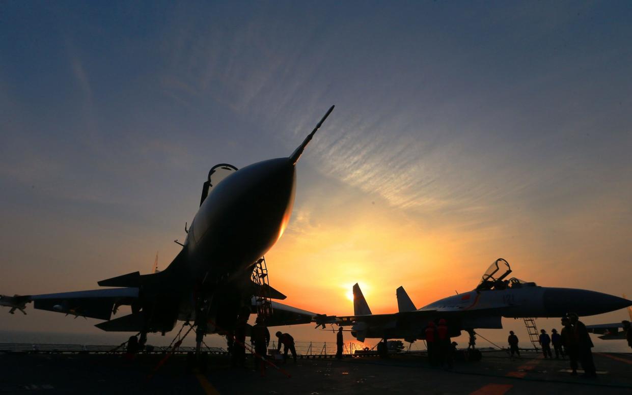 J15 fighter jets on China's sole operational aircraft carrier, the Liaoning, during a drill at sea - AFP