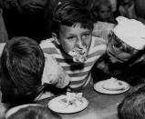 <p>His Mouth Full, his face smeared, one contestant comes up for air while his opponents dig deeper into their pie in the course of the pie-eating contest at Central City’s July Fourth celebration in Colo., 1947. The afternoon’s events, in addition to pie eating, included three-legged races, a greased pig, and other traditional contests. (Photo: Denver Post via Getty Images) </p>