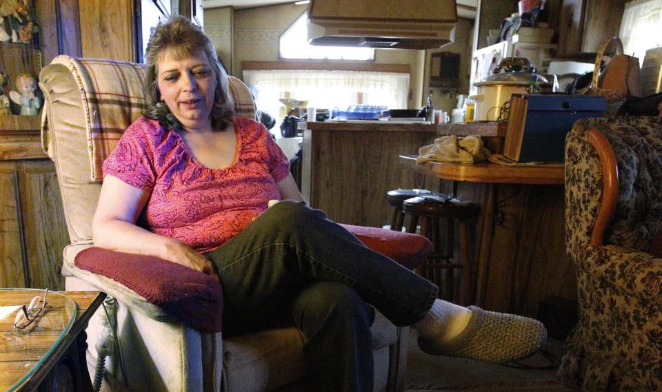 In this photo made on Tuesday, April 10, 2012, Janet McIntyre talks about the water from her well while sitting in her home in Evans City, Pa. McIntyre, whose home is near a gas well drilled using the hydraulic fracturing process, said doctors told her not to drink or bathe in the water after test results showed traces of chemicals. She lives in one of ten households in a neighborhood 30 miles north of Pittsburgh, where residents feel nearby drilling has impacted their water. State and industry experts say tests have shown the water is fine. (AP Photo/Keith Srakocic)