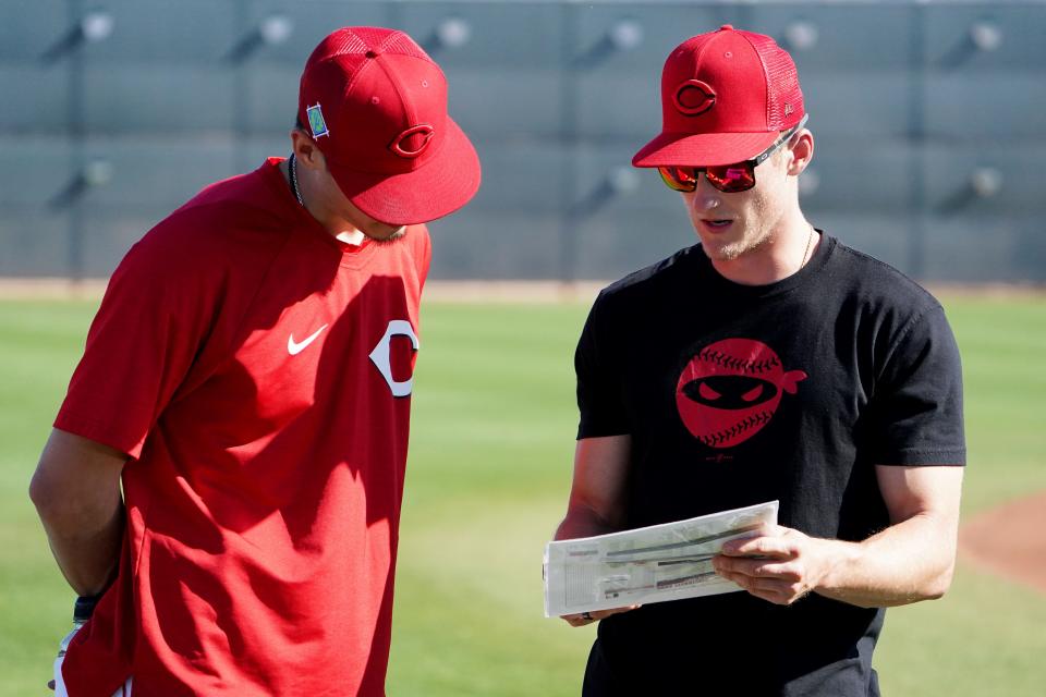 Former Reds assistant pitching coach Eric Jagers, right, speaks with former Reds pitcher Riley O'Brien during a spring training workout in 2022.