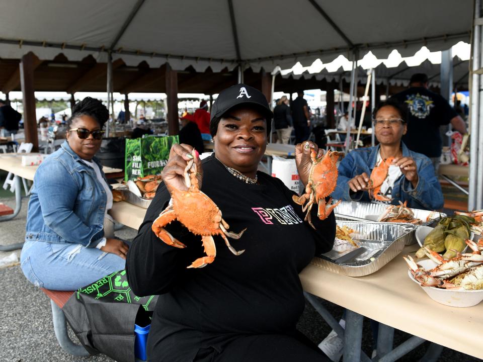 Ayanna Horsey shows off her crabs at the J. Millard Tawes Crab and Clam Bake Wednesday, Sept. 27, 2023, at Somers Cove Marina in Crisfield, Maryland.