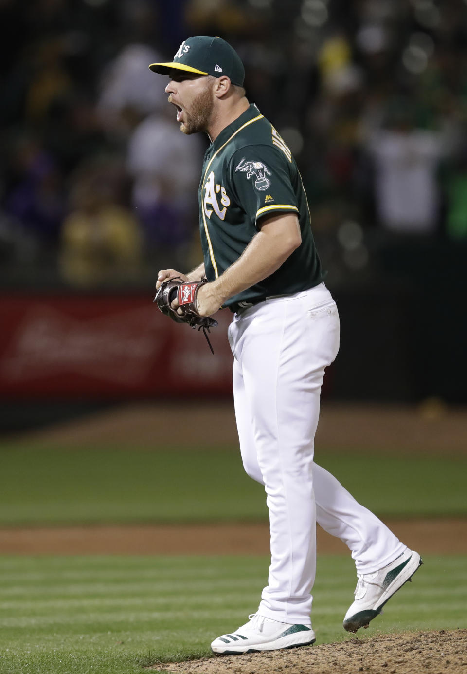 Oakland Athletics pitcher Liam Hendriks celebrates the team's 8-6 win over the Minnesota Twins in a baseball game Tuesday, July 2, 2019, in Oakland, Calif. (AP Photo/Ben Margot)