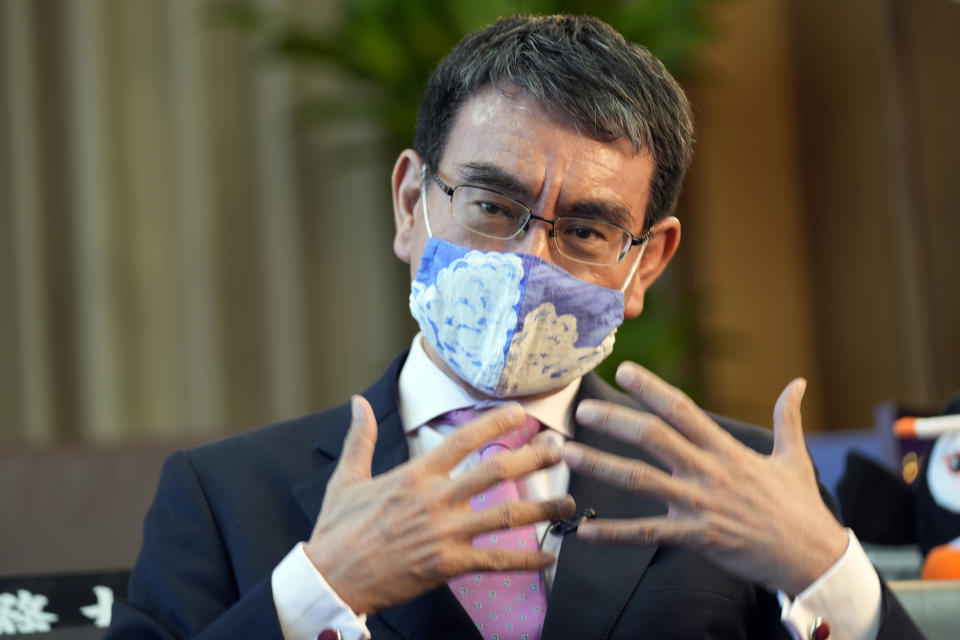 FILE - In this July 28, 2021, file photo, Taro Kono, Japan's minister in charge of a huge vaccination campaign, speaks during an interview with The Associated Press at his office in Tokyo. Kono promised Sunday, Aug. 29, 2021 a timely administering of booster shots for the coronavirus, as the nation aims to fully vaccinate its population by October or November. (AP Photo/Eugene Hoshiko, File)