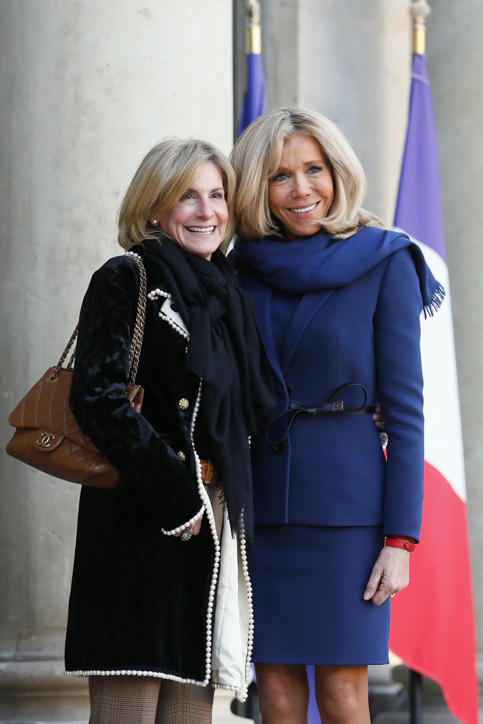 Brigitte Macron, wife of French President Emmanuel Macron, right, poses with U.S ambassador to France Jamie McCourt before a meeting on gender equality ahead of the upcoming G7, Tuesday, Feb.19, 2019 at the Elysee Palace in Paris. (AP Photo/Francois Mori)