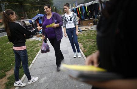 Volunteers hand leaflets with information about new Bosnia's census in Jablanica, 60 kilometres (37 miles) south of Sarajevo, September 27, 2013. REUTERS/Dado Ruvic