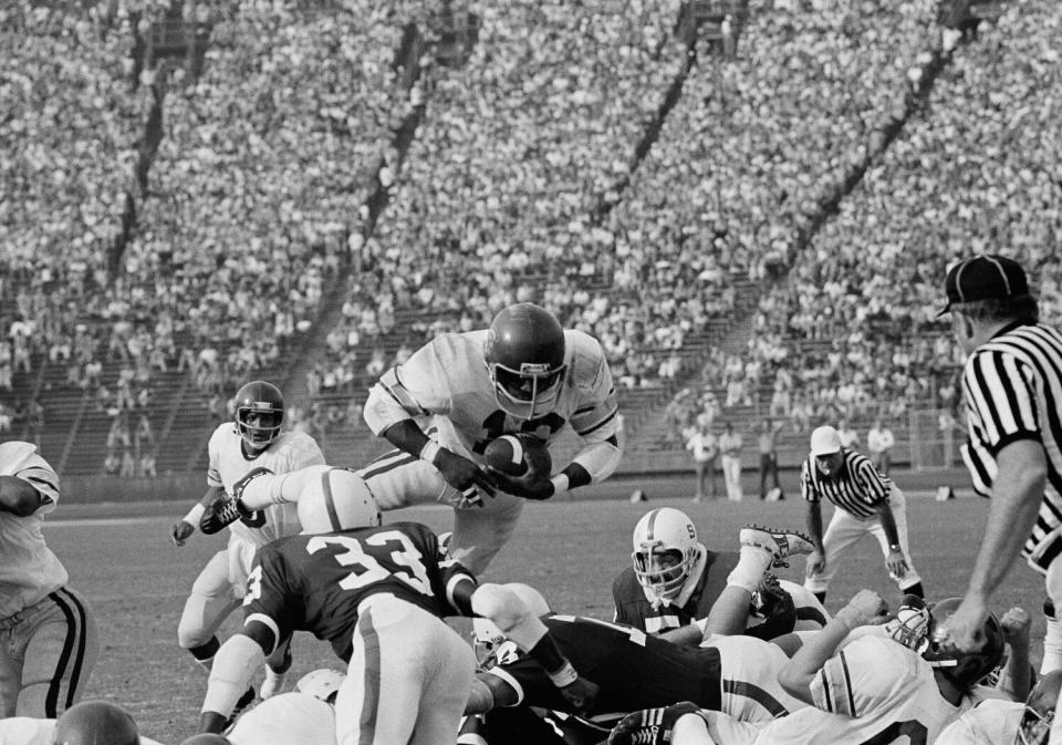 USC tailback Charles White goes up and over for a touchdown against Stanford.