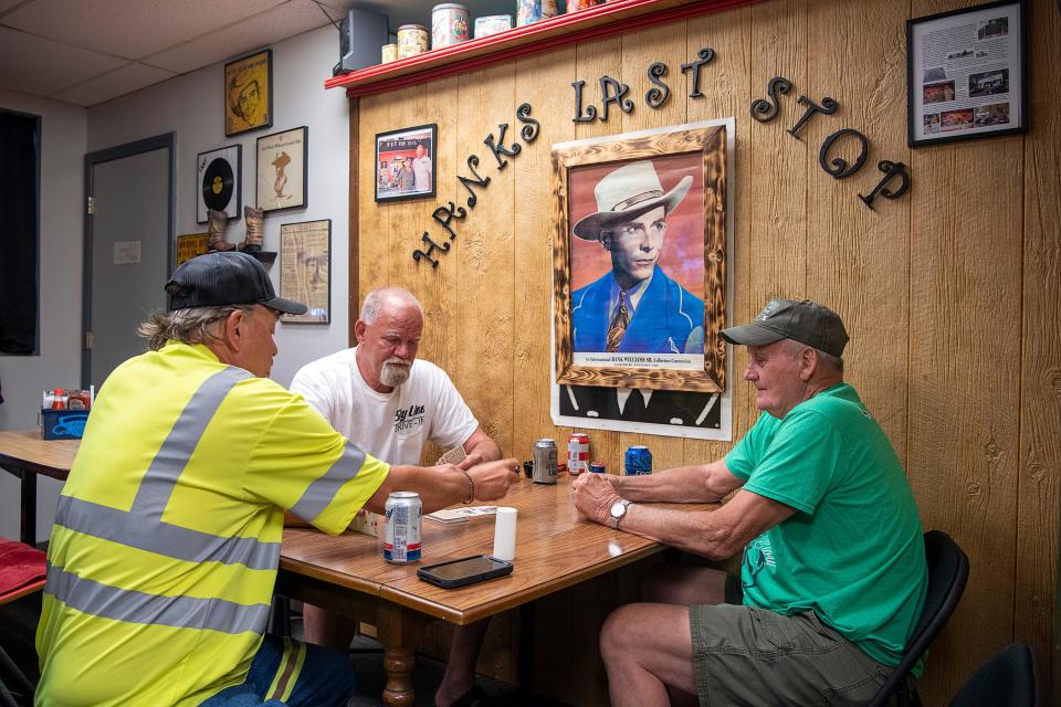 A group of buddies, including co-owner Ricky Green, center, play a game of cards at Skyline Drive-In: Hank’s Last Stop, in Oak Hill, W.Va. It’s said that country music legend Hank Williams died shortly before his cab driver arrived at the property in 1953.