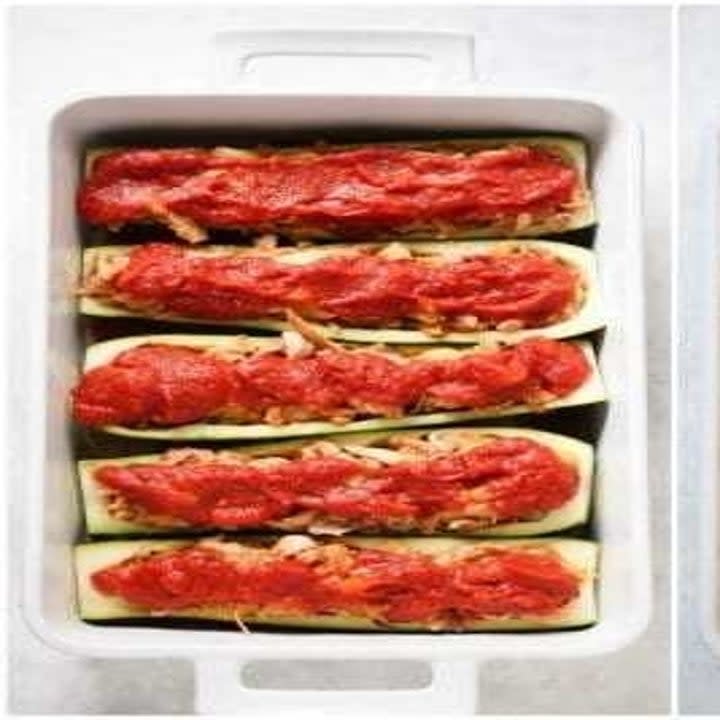 Zucchini boats filled with cheese and topped with tomato sauce