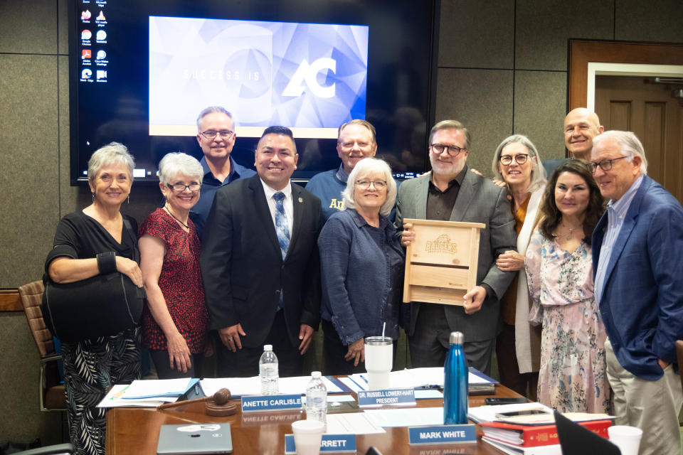 Members of the Board of Regents of the Amarillo Junior College District share a photo Tuesday with departing president Russell Lowery-Hart and his custom Amarillo College bat house.