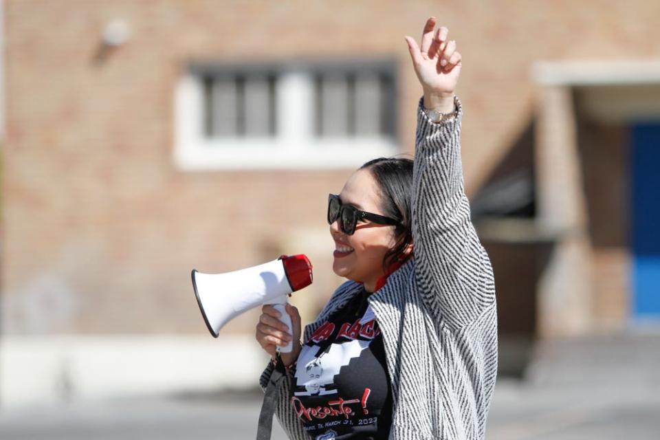 La Fe Preparatory School Principal Marina Lopez chants with students, "Si se puede," during the La Fe Children’s César Chávez Day March on Friday.