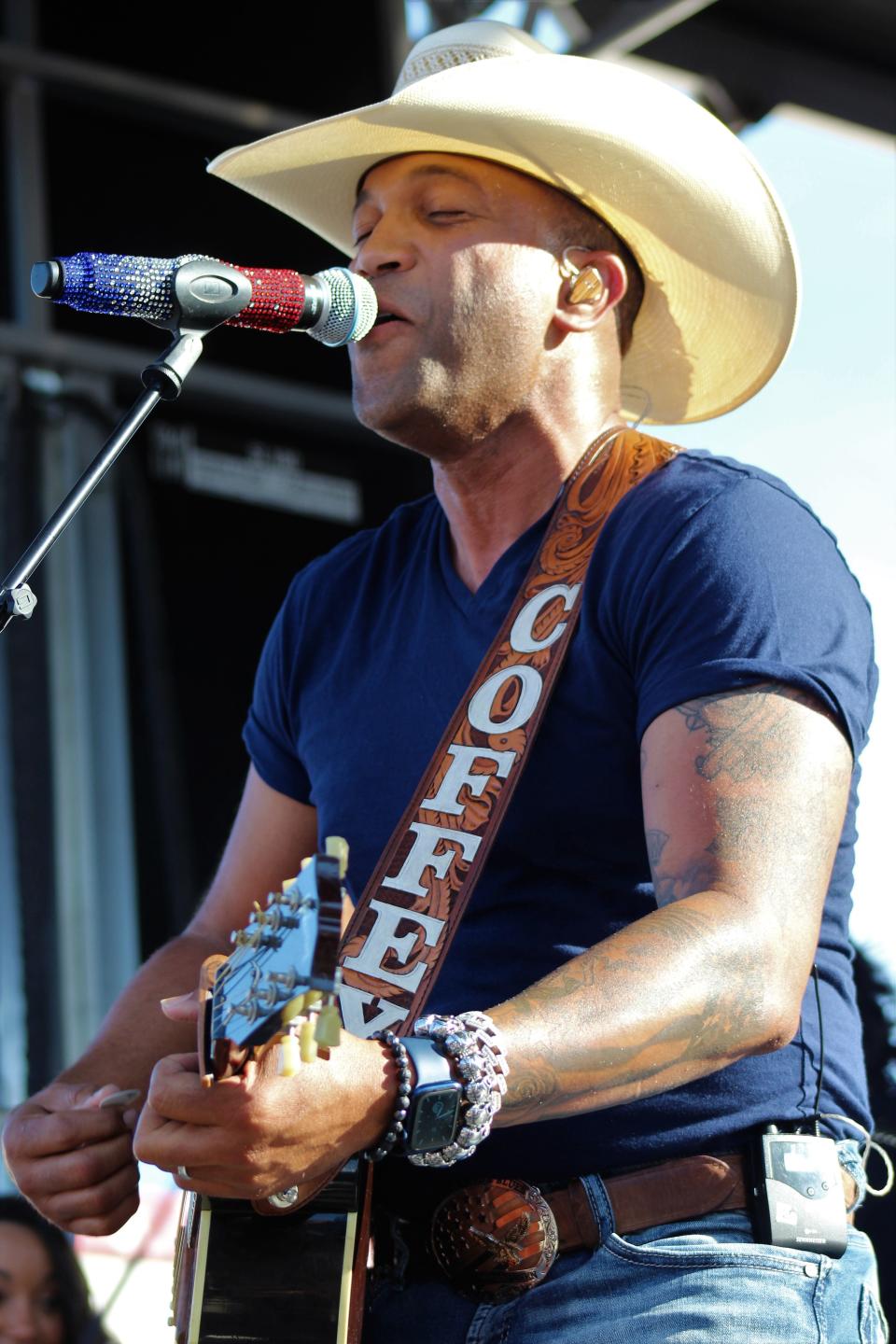 Country singer Coffey Anderson with his red, white and blue microphone at his June show in Abilene. He is at the Allsup's in Merkel on Friday.