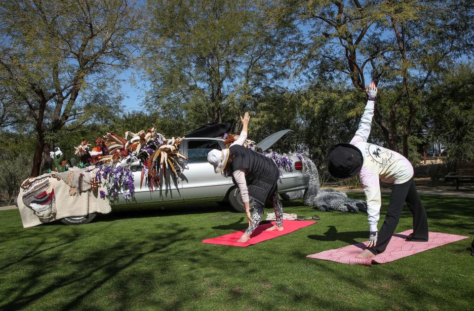 Suzee Miller, right, and Marsha Lostracco do yoga near the artwork at Sunnylands Center and Gardens in Rancho Mirage, Calif., March 3, 2023.